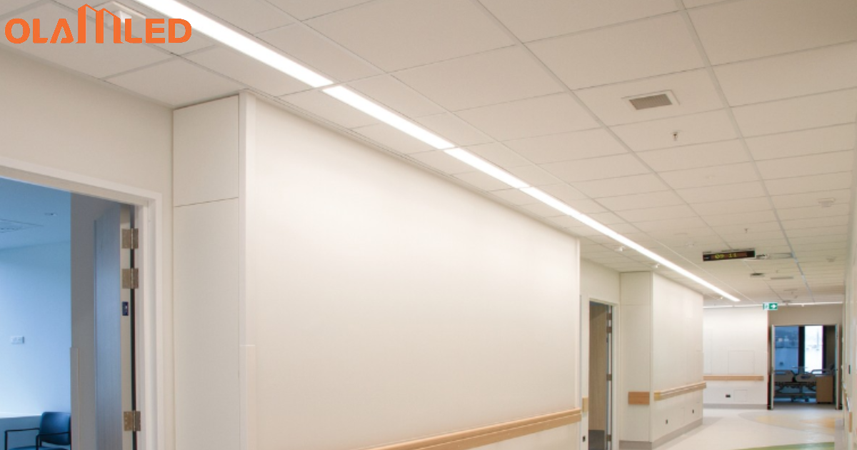 A hospital hallway featuring led cleanroom troffer lighting with a white light illuminating the wall