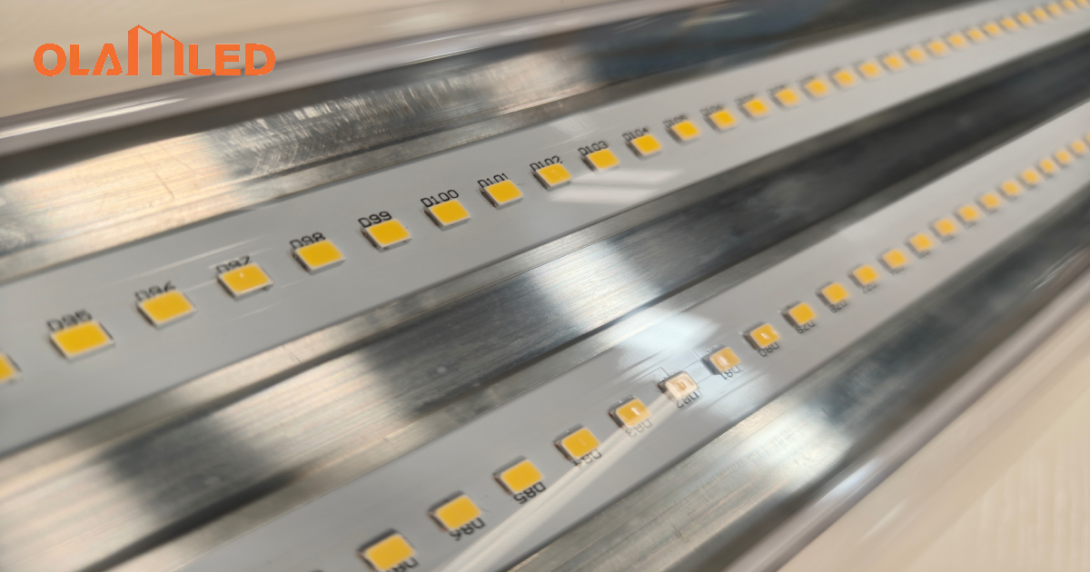 Close up image of a metal strip with bright yellow led light beads shining.
