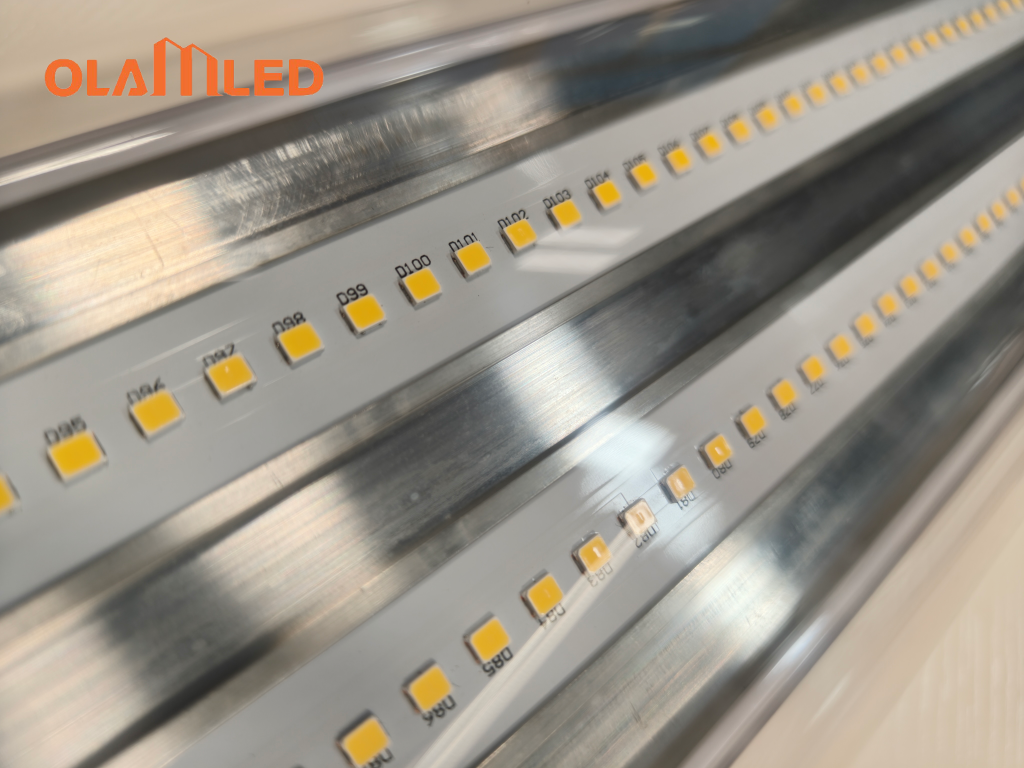 Close up image of a metal strip with bright yellow led light beads shining.