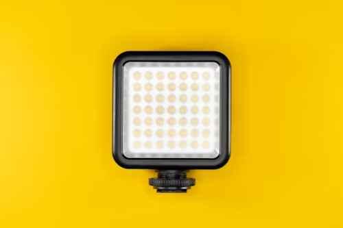 Led light glowing white on a cheerful yellow background, enhancing visual appeal.