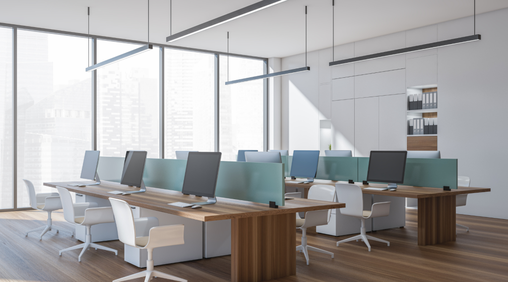 Open plan office with wooden desks, glass partitions, and suspended led linear lights