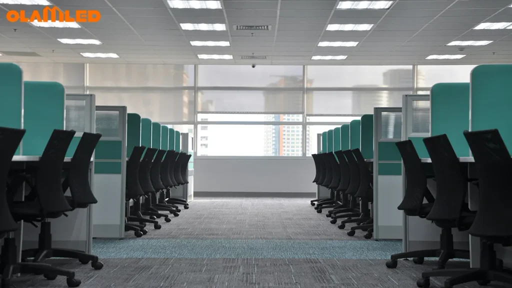 Recessed square LED panel lights installed on open-plan commercial office ceiling grid